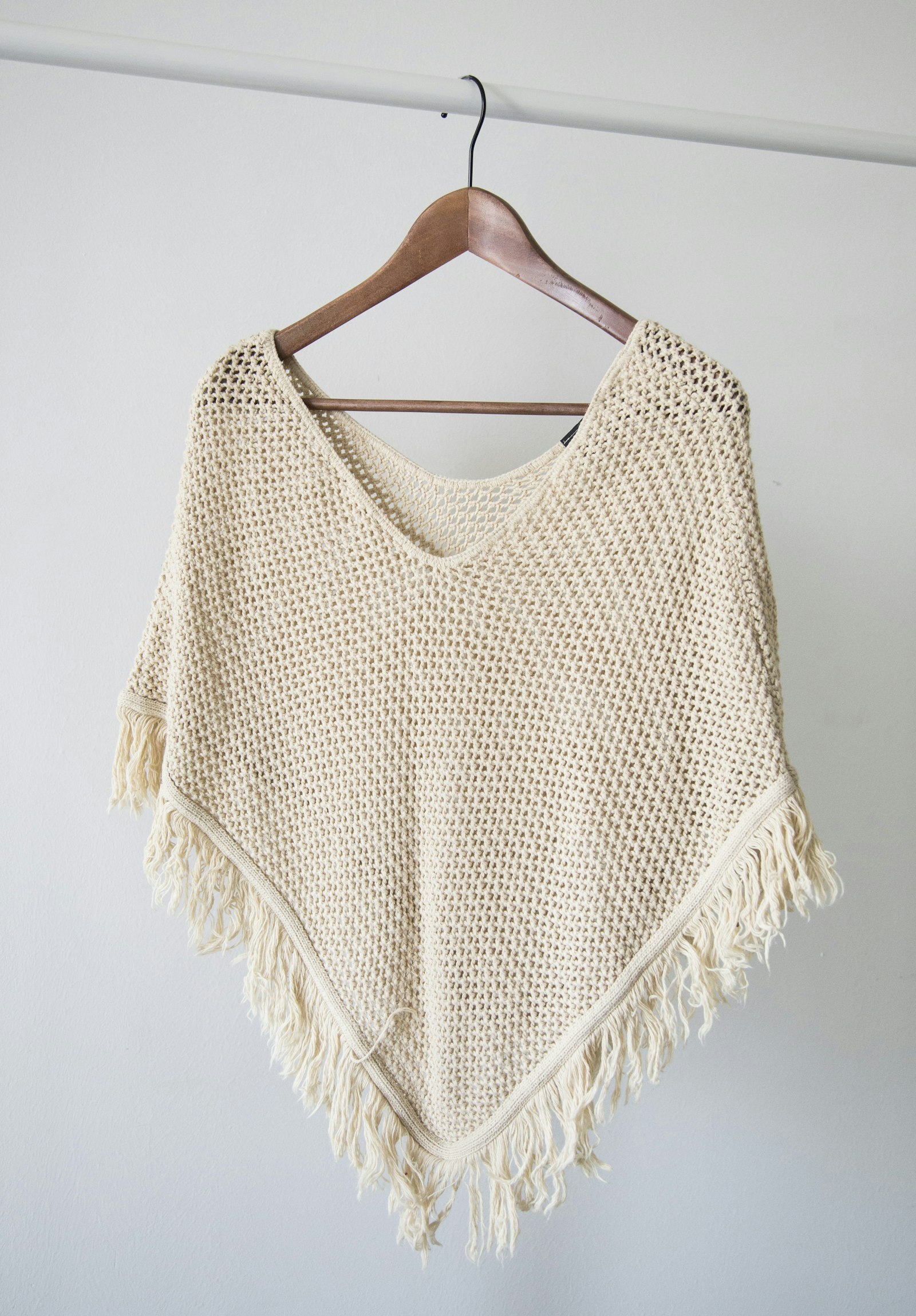 Merino blend knit sweaters hanging on a rail
